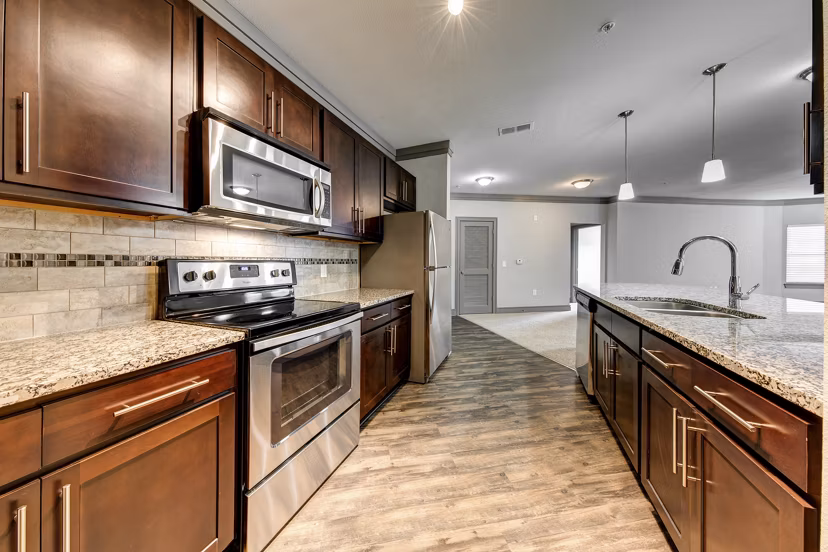 Modern kitchen with stainless steel appliances at The Manor at Weston Apartments, Greystar luxury living