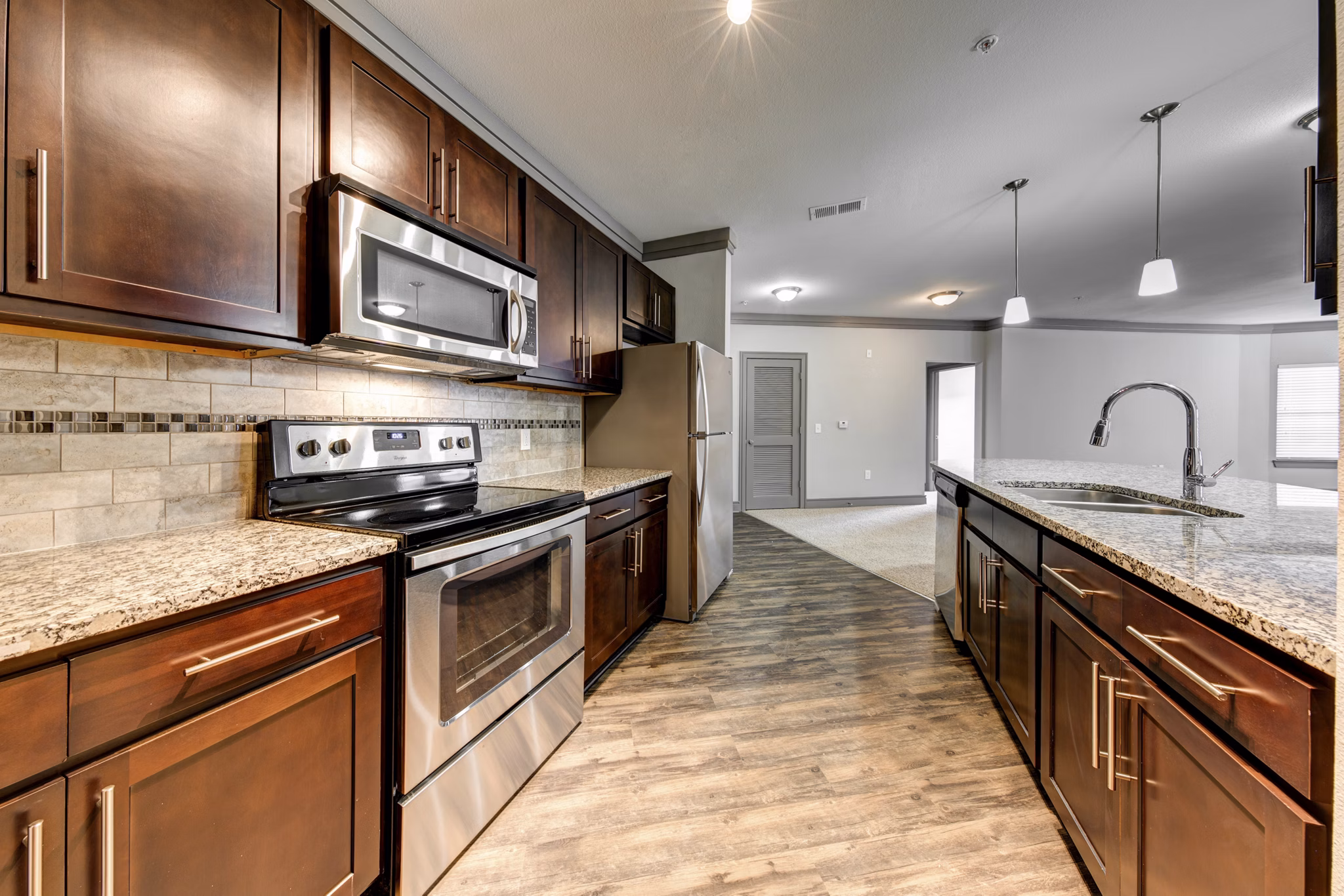 Modern kitchen with stainless steel appliances at The Manor at Weston Apartments, Greystar luxury living