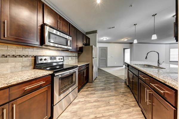 Modern kitchen with stainless steel appliances at The Manor at Weston Apartments, Greystar luxury living