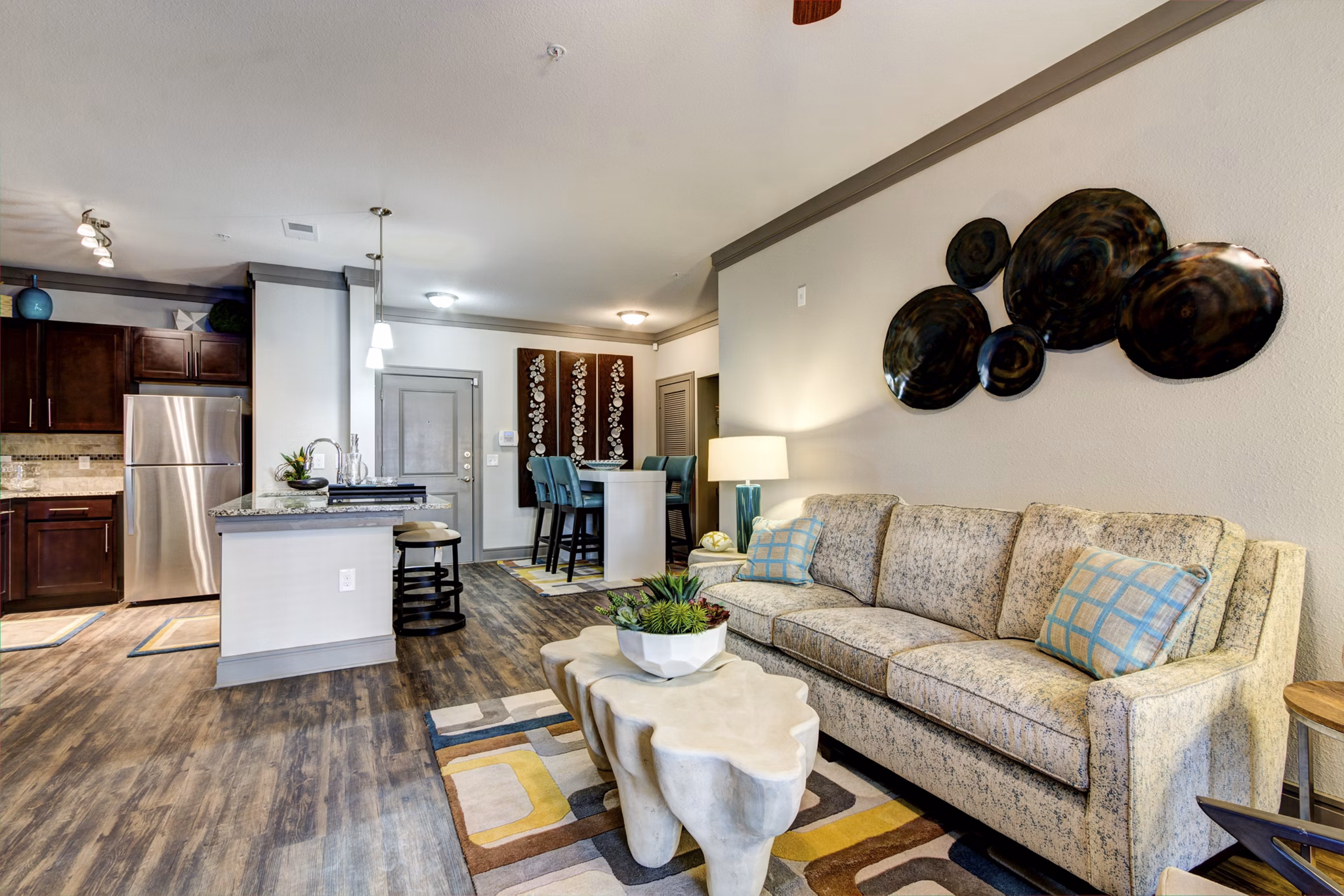 Modern living room with plush seating and large windows in The Manor at Weston Apartments