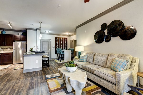 Modern living room with plush seating and large windows in The Manor at Weston Apartments