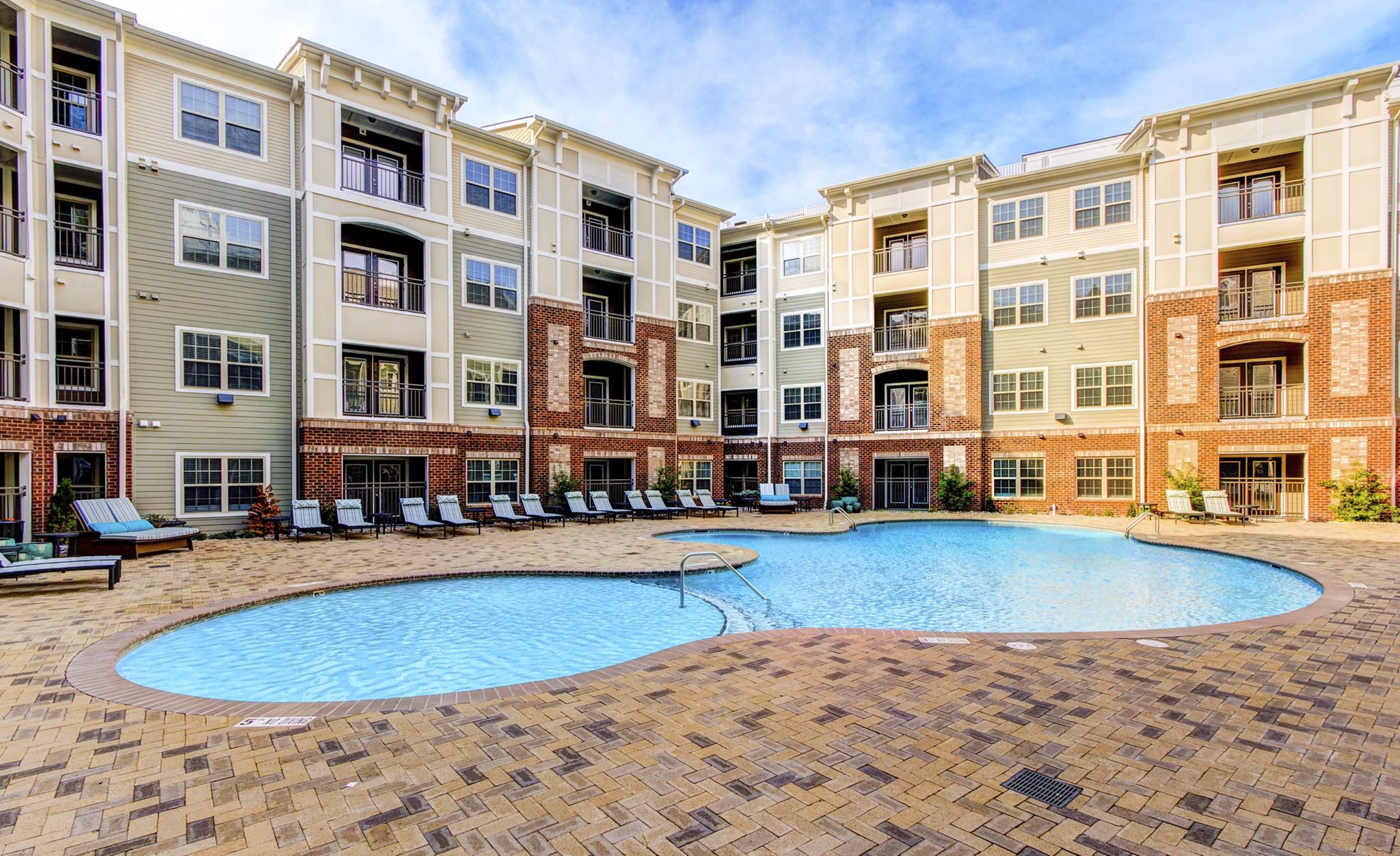 Beautiful pool area with lounge seating at The Manor at Weston Apartments