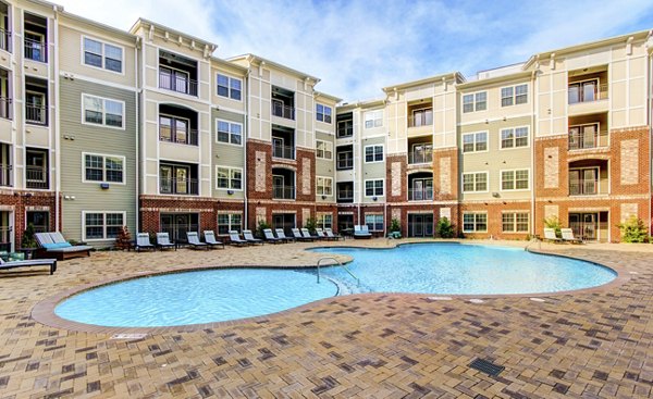 Beautiful pool area with lounge seating at The Manor at Weston Apartments