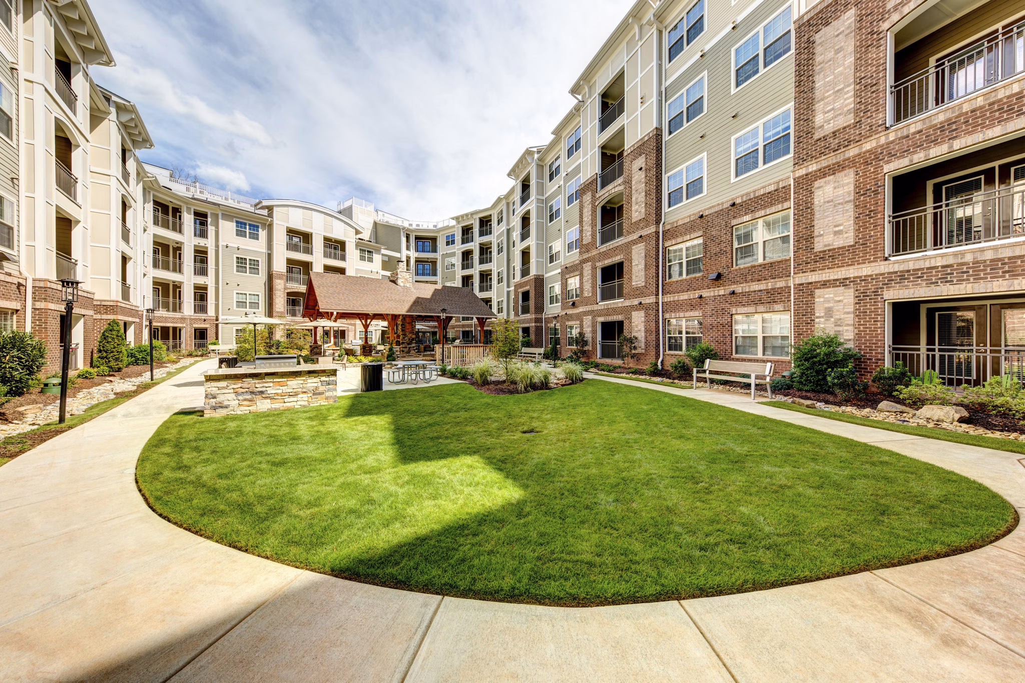 Outdoor grill area at The Manor at Weston Apartments featuring modern barbecue stations and seating for residents