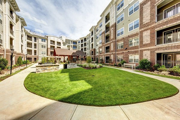 Outdoor grill area at The Manor at Weston Apartments featuring modern barbecue stations and seating for residents