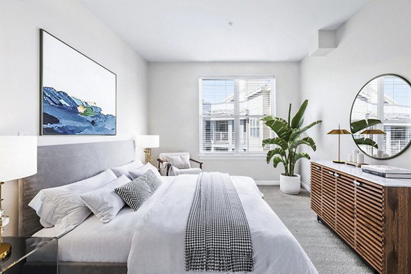 Cozy bedroom with modern furnishings at Pike3400 Apartments