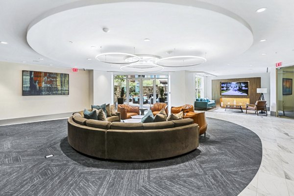 Clubhouse lobby with modern decor and seating at Pike3400 Apartments