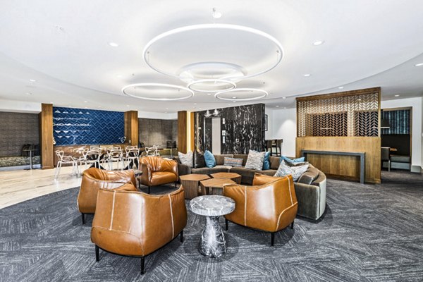 Clubhouse lobby with modern decor and seating area at Pike3400 Apartments