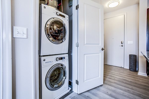 Laundry room featuring modern appliances at Pike3400 Apartments luxury apartments