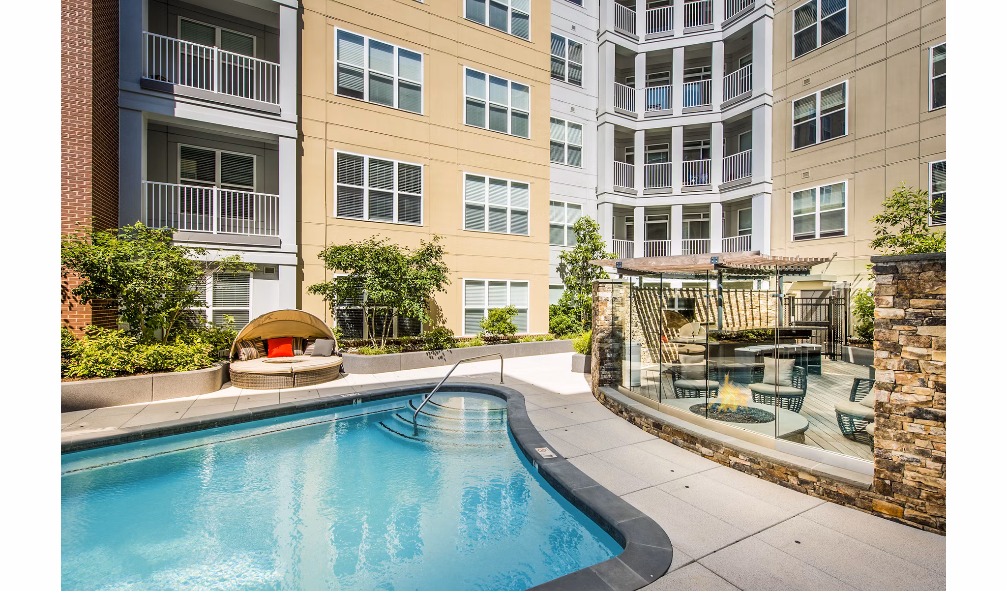 Resort-style pool with lounge chairs at Pike3400 Apartments in Seattle, offering luxury relaxation for residents