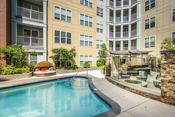 Resort-style pool with lounge chairs at Pike3400 Apartments in Seattle, offering luxury relaxation for residents