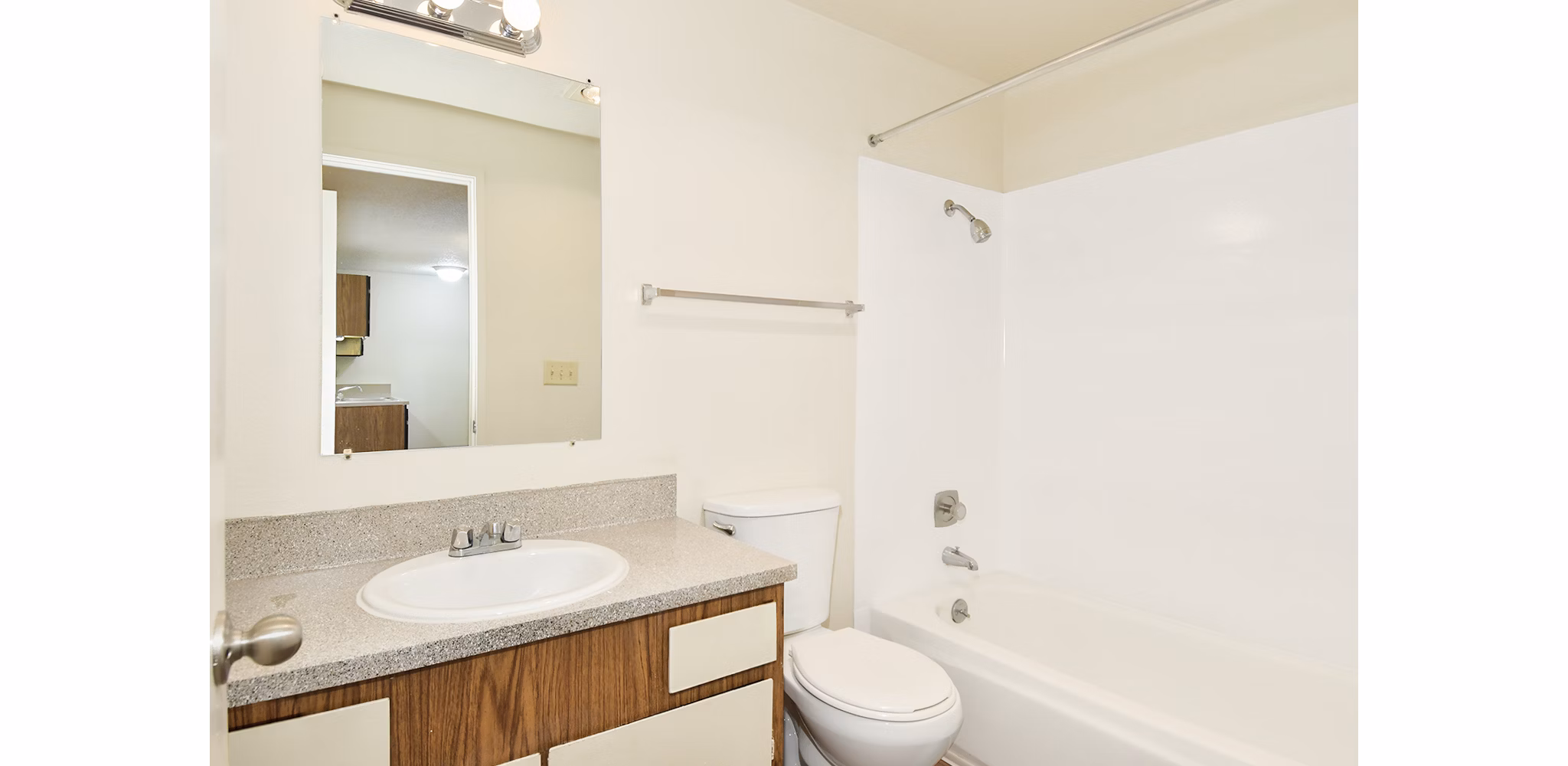 Modern bathroom with sleek fixtures and large mirror at Lake Crest Apartments