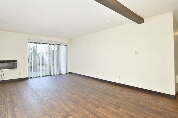Spacious, modern living room with natural light at Lake Crest Apartments, featuring stylish furnishings and a cozy atmosphere