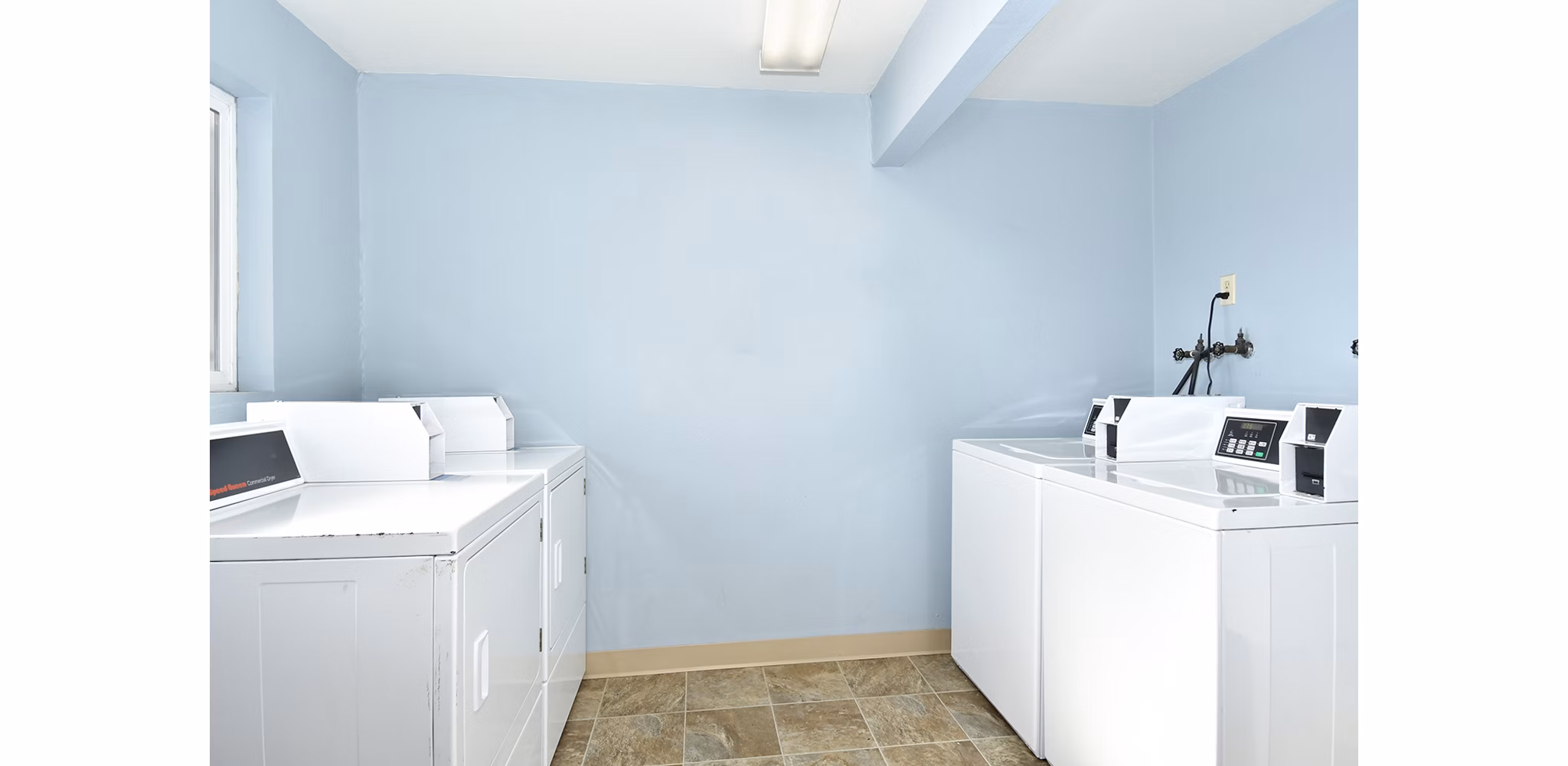 Modern laundry facility with energy-efficient machines at Lake Crest Apartments, ideal for convenient living