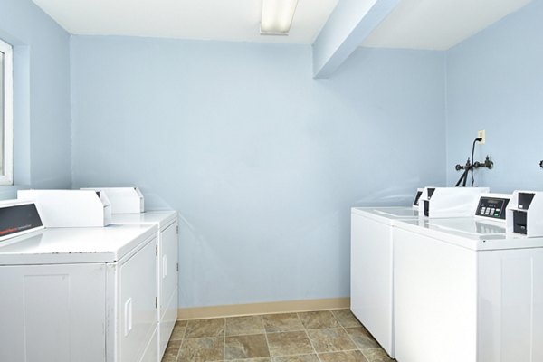Modern laundry facility with energy-efficient machines at Lake Crest Apartments, ideal for convenient living