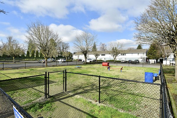 Spacious dog park with agility equipment at Lake Crest Apartments, perfect for pet-friendly living in a Greystar community