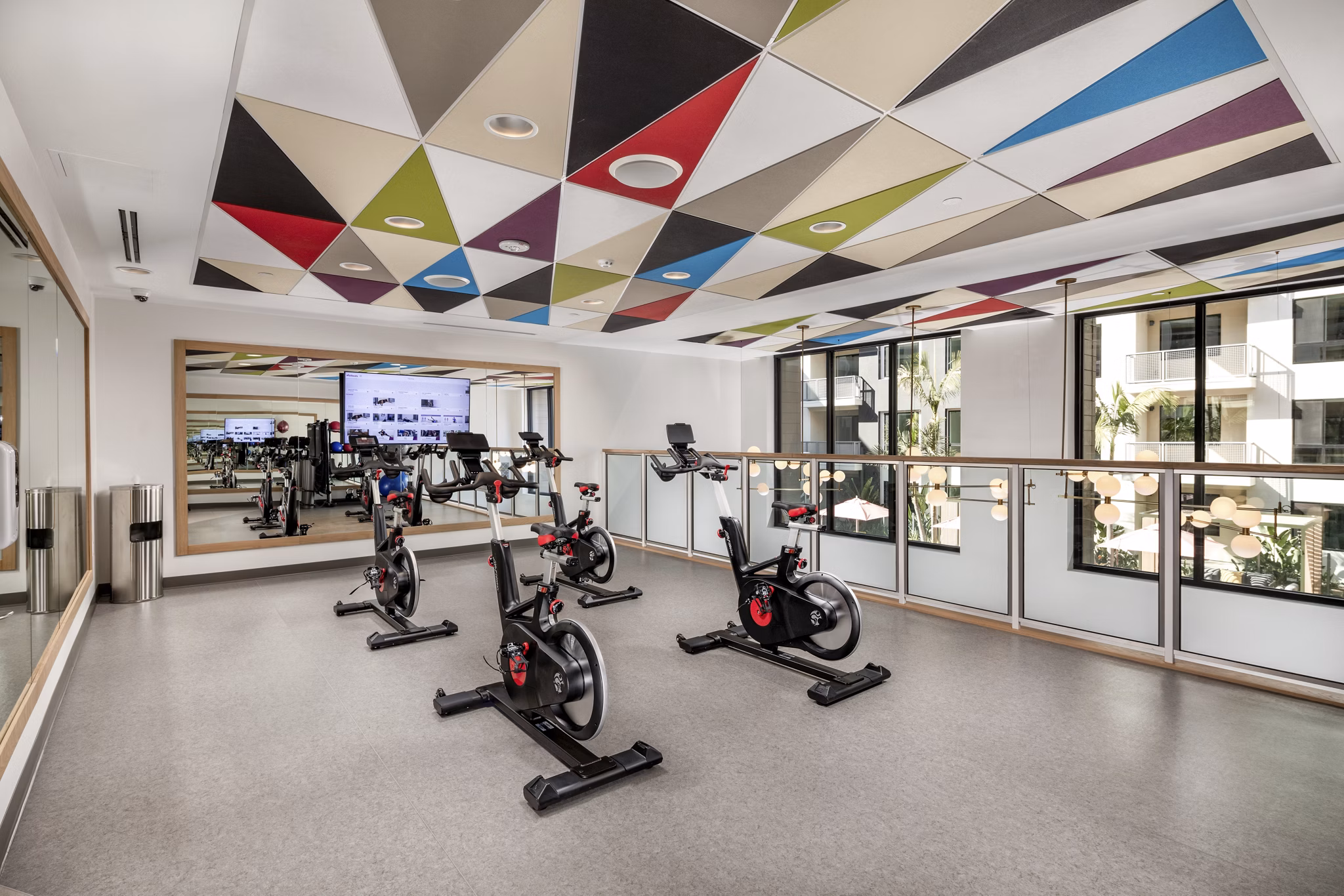 Modern yoga and spin studio with natural light at Cameo Apartments by Greystar