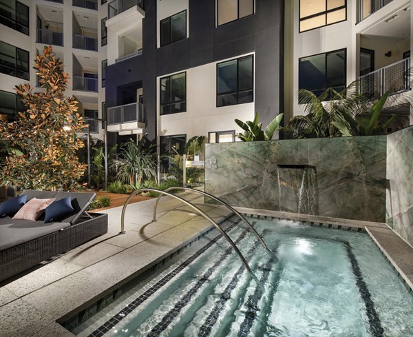 Rooftop swimming pool at Cameo Apartments with city skyline views
