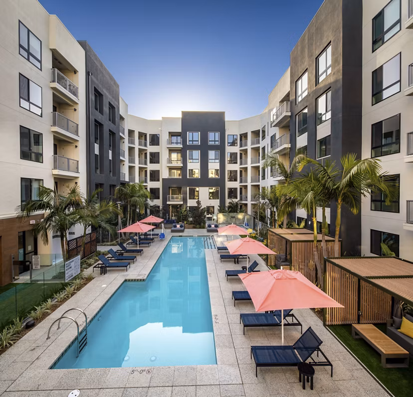 Olympic-sized pool with lounge chairs at Cameo Apartments, ideal for luxury living seekers and swimming enthusiasts
