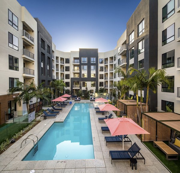 Olympic-sized pool with lounge chairs at Cameo Apartments, ideal for luxury living seekers and swimming enthusiasts