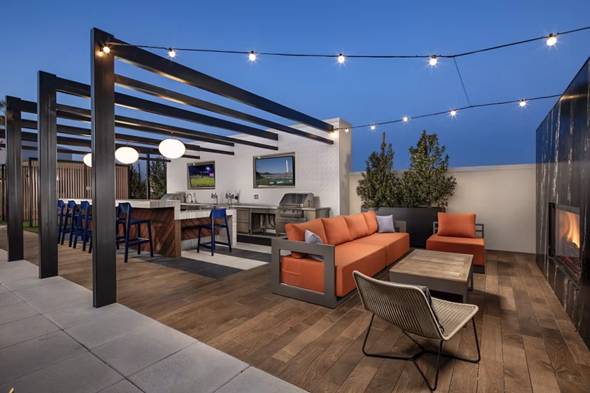 Scenic rooftop deck with lounge seating at Cameo Apartments providing panoramic views of Seattle skyline