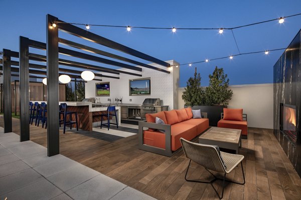 Scenic rooftop deck with lounge seating at Cameo Apartments providing panoramic views of Seattle skyline