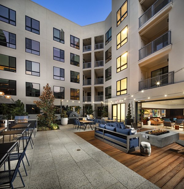 Cameo Apartments: Tranquil courtyard with lush greenery and seating areas in luxury Greystar community