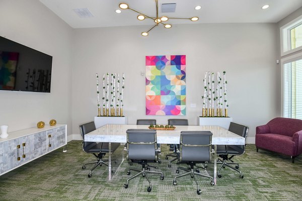 Meeting room featuring modern design and presentation equipment at Isla Apartments, luxury living by Greystar