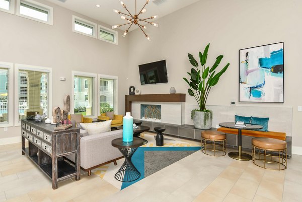 Modern clubhouse featuring stylish seating and gaming areas at Isla Apartments in Greystar community