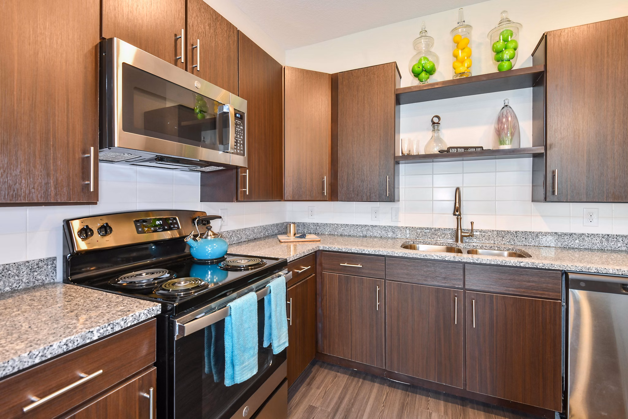 Contemporary kitchen with stainless steel appliances at Isla Apartments