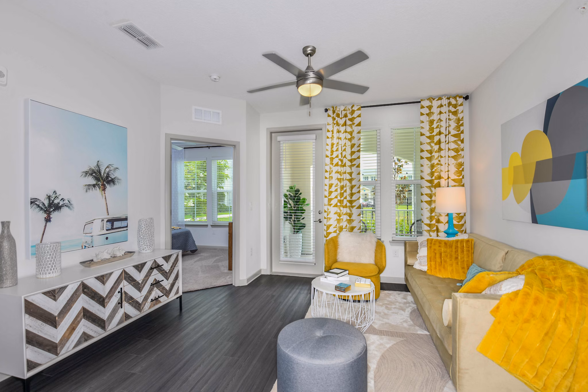 Contemporary living room with stylish decor and large windows at Isla Apartments, a Greystar luxury community
