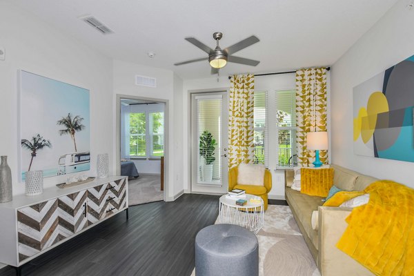 Contemporary living room with stylish decor and large windows at Isla Apartments, a Greystar luxury community