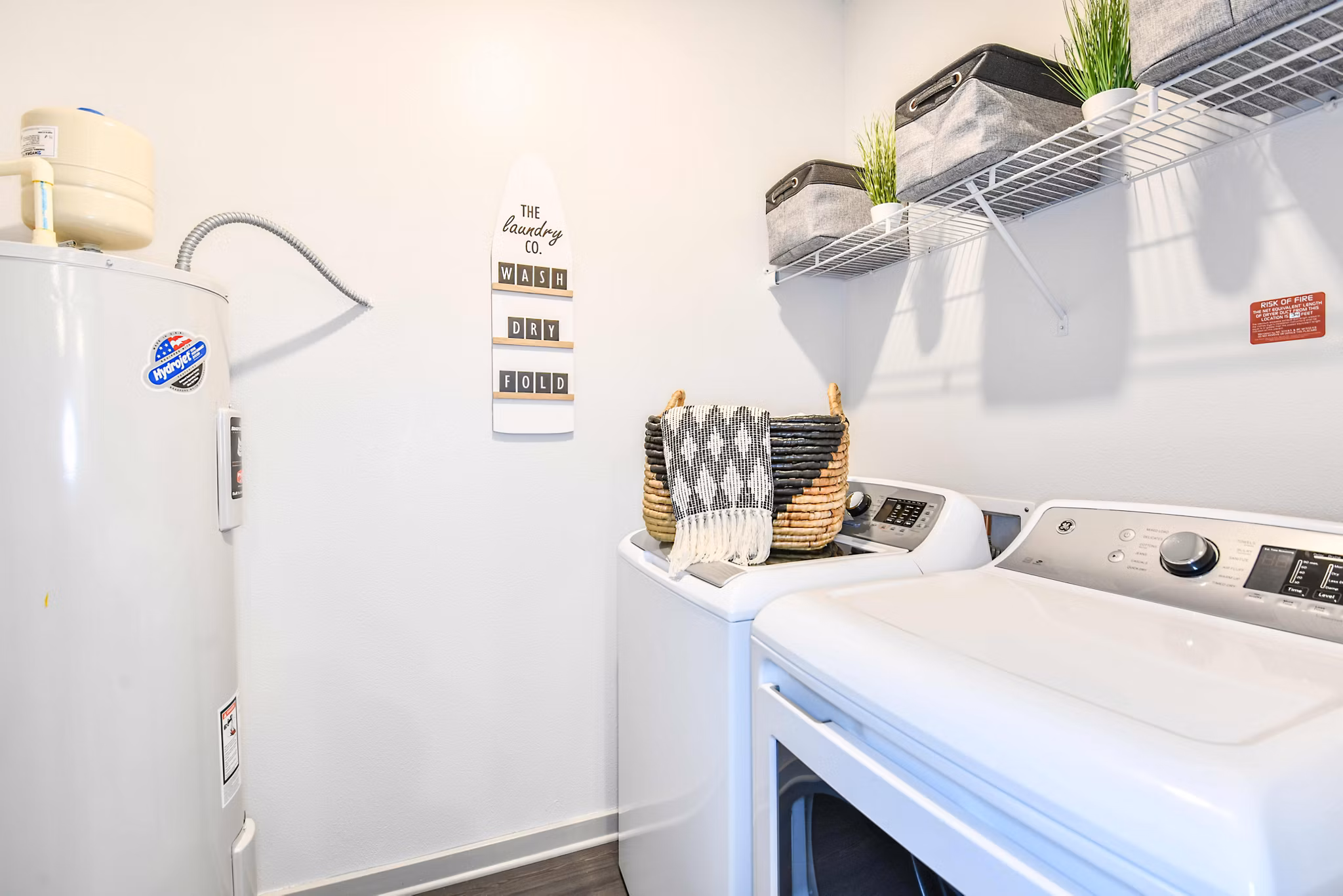 Laundry room with eco-friendly washers and dryers at Isla Apartments