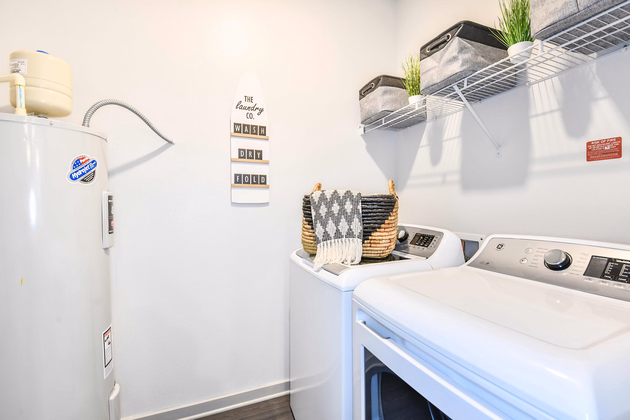 Laundry room with eco-friendly washers and dryers at Isla Apartments