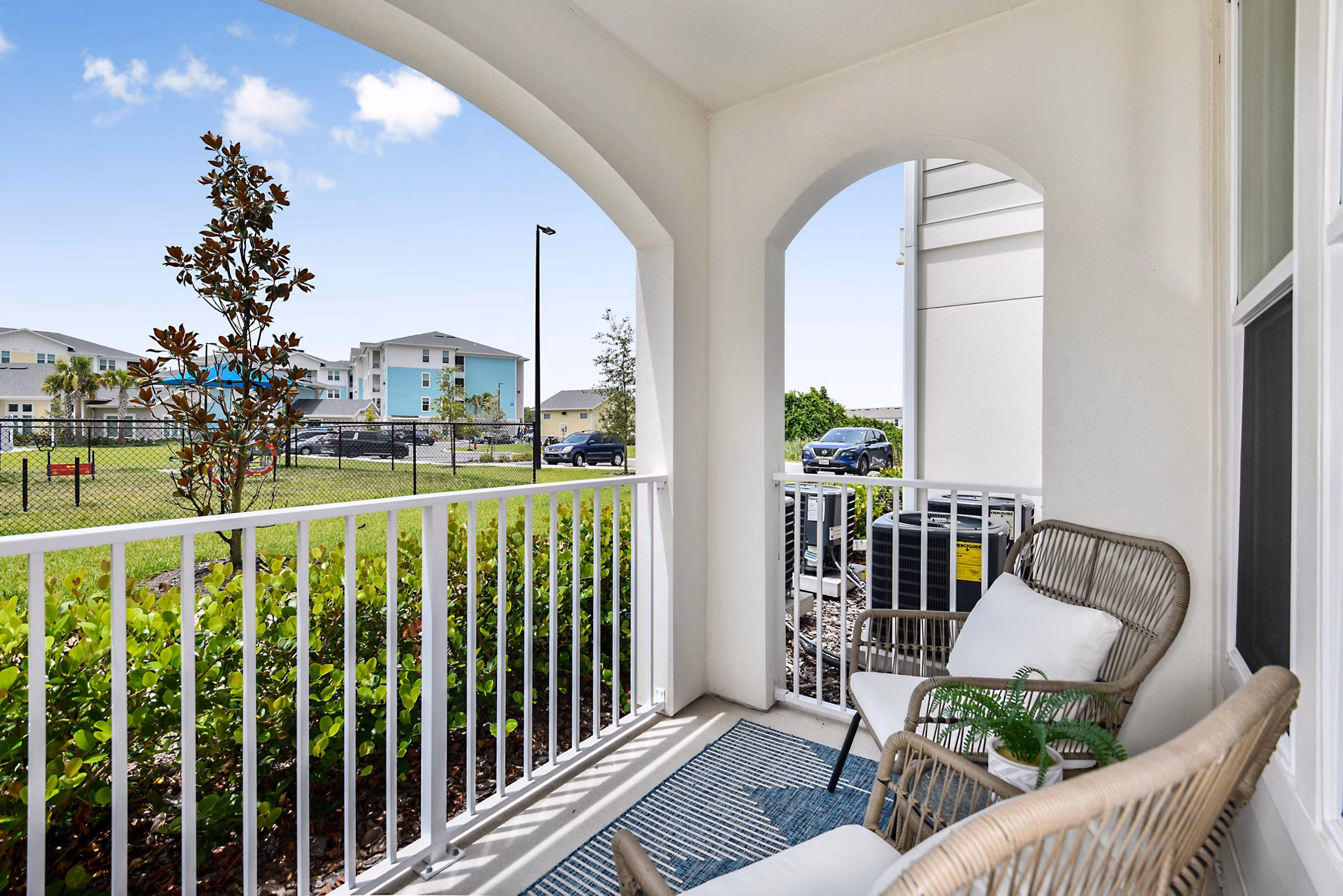 Patio with outdoor seating at Isla Apartments, offering luxury living in a scenic setting