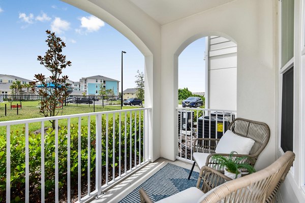 Patio with outdoor seating at Isla Apartments, offering luxury living in a scenic setting