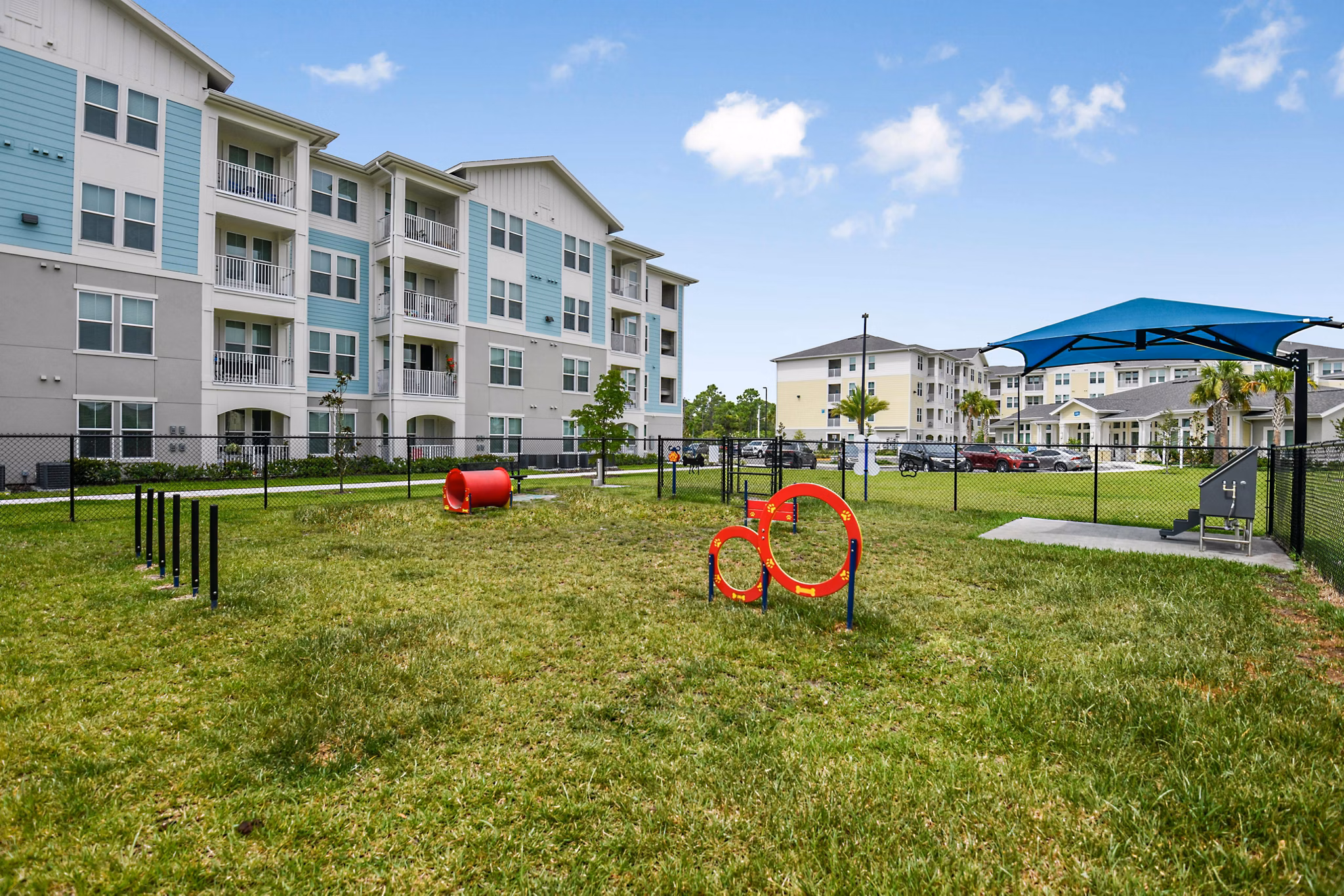 Dog-friendly outdoor park with agility equipment at Isla Apartments