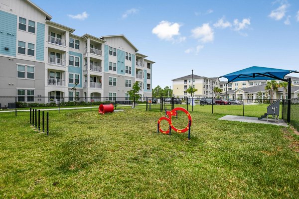 Dog-friendly outdoor park with agility equipment at Isla Apartments