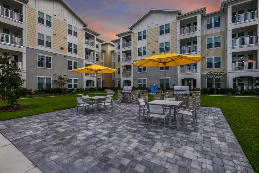 Outdoor grill area with modern seating at Isla Apartments