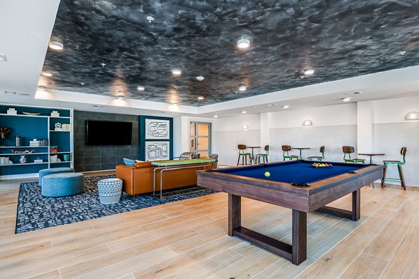 Game room featuring pool table and modern seating at Renaissance Santa Rosa Apartments