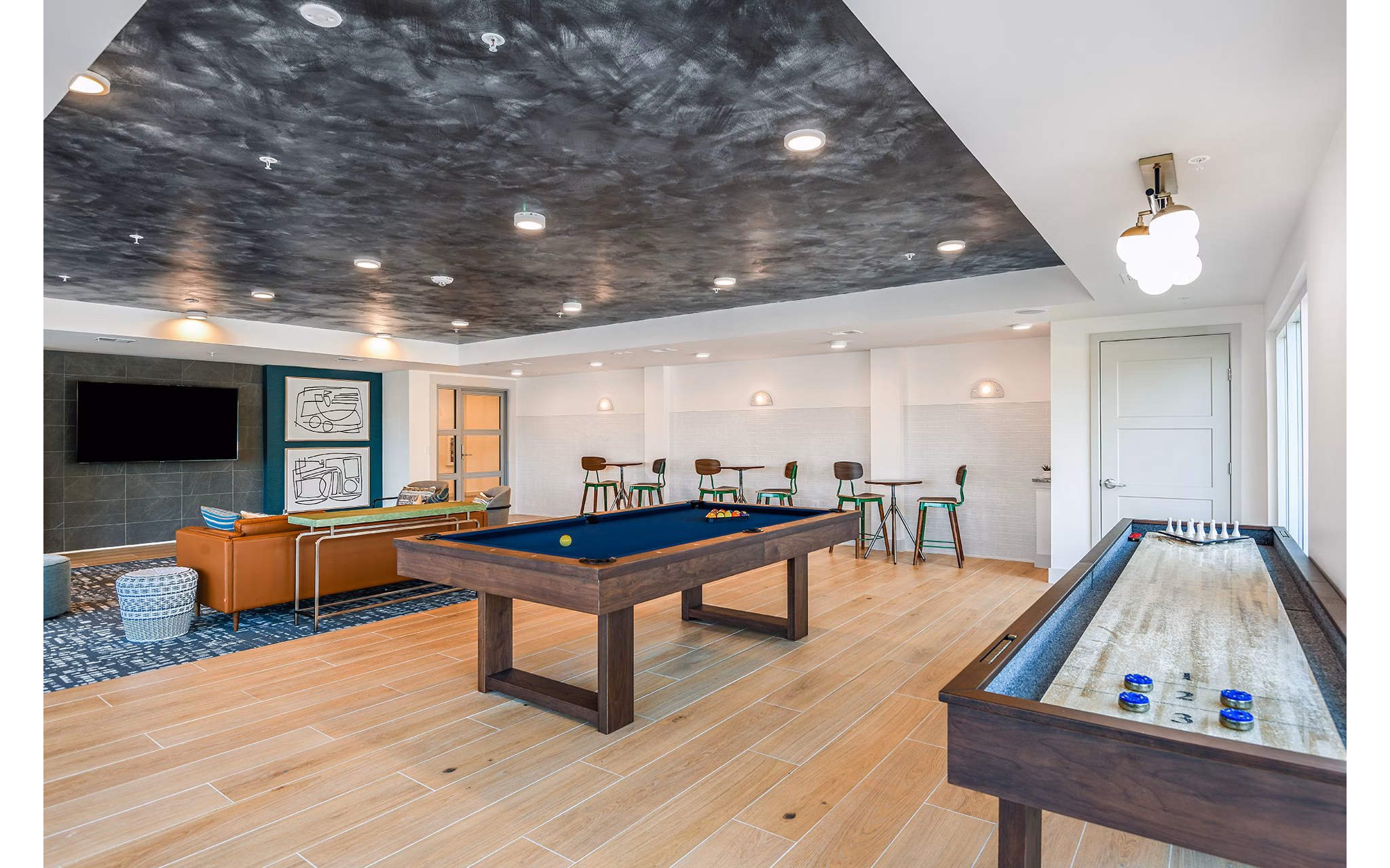 Game room with pool table and arcade machines at Renaissance Santa Rosa Apartments