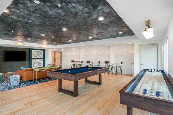 Game room with pool table and arcade machines at Renaissance Santa Rosa Apartments