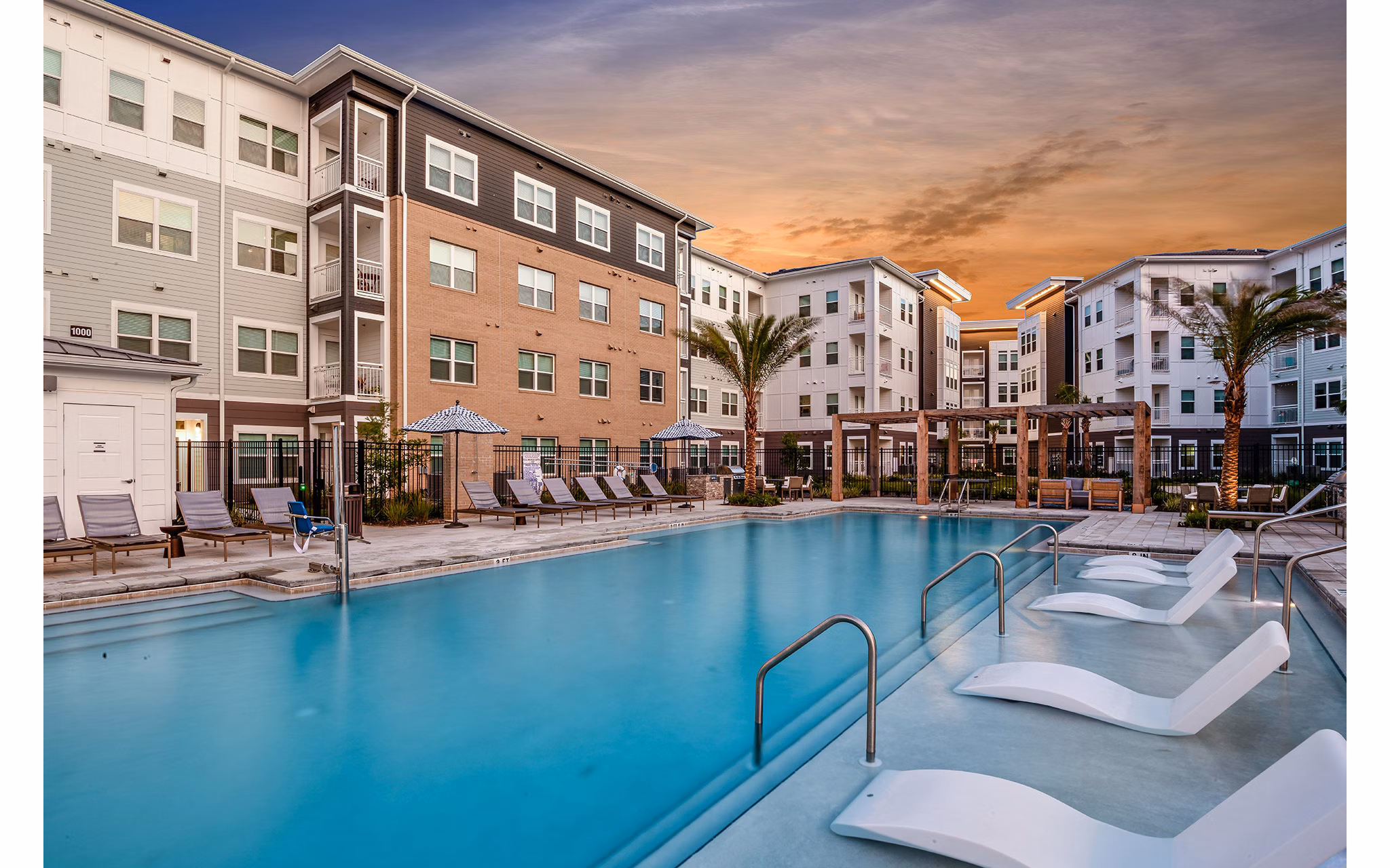 Relaxing pool area with lounge chairs at Renaissance Santa Rosa Apartments