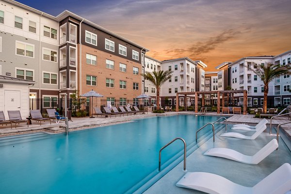 Relaxing pool area with lounge chairs at Renaissance Santa Rosa Apartments