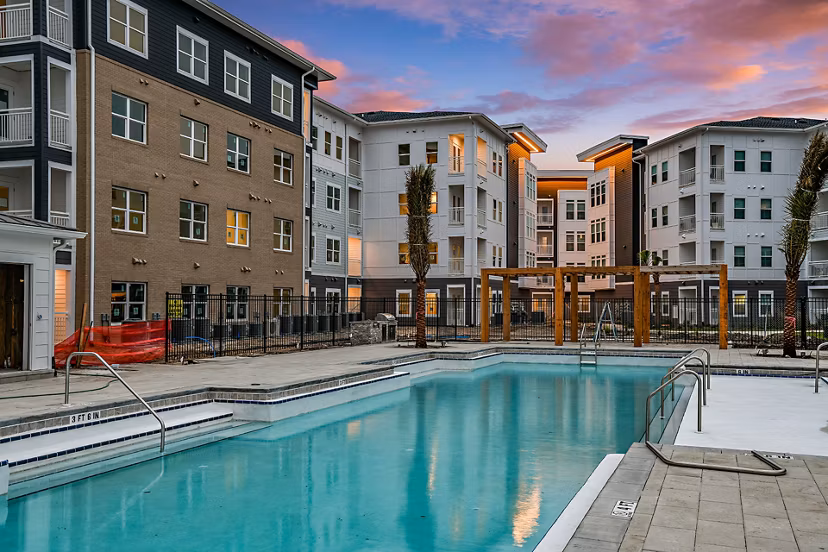Olympic-sized pool with lounge chairs at Renaissance Santa Rosa Apartments, perfect for relaxation and recreation in a luxury setting