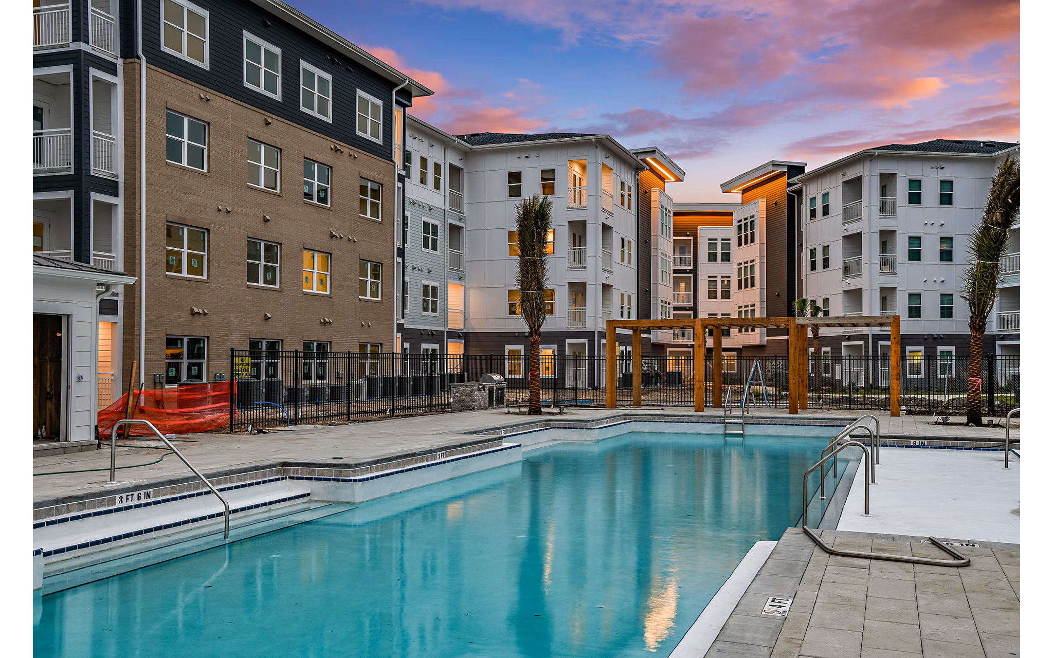 Olympic-sized pool with lounge chairs at Renaissance Santa Rosa Apartments, perfect for relaxation and recreation in a luxury setting