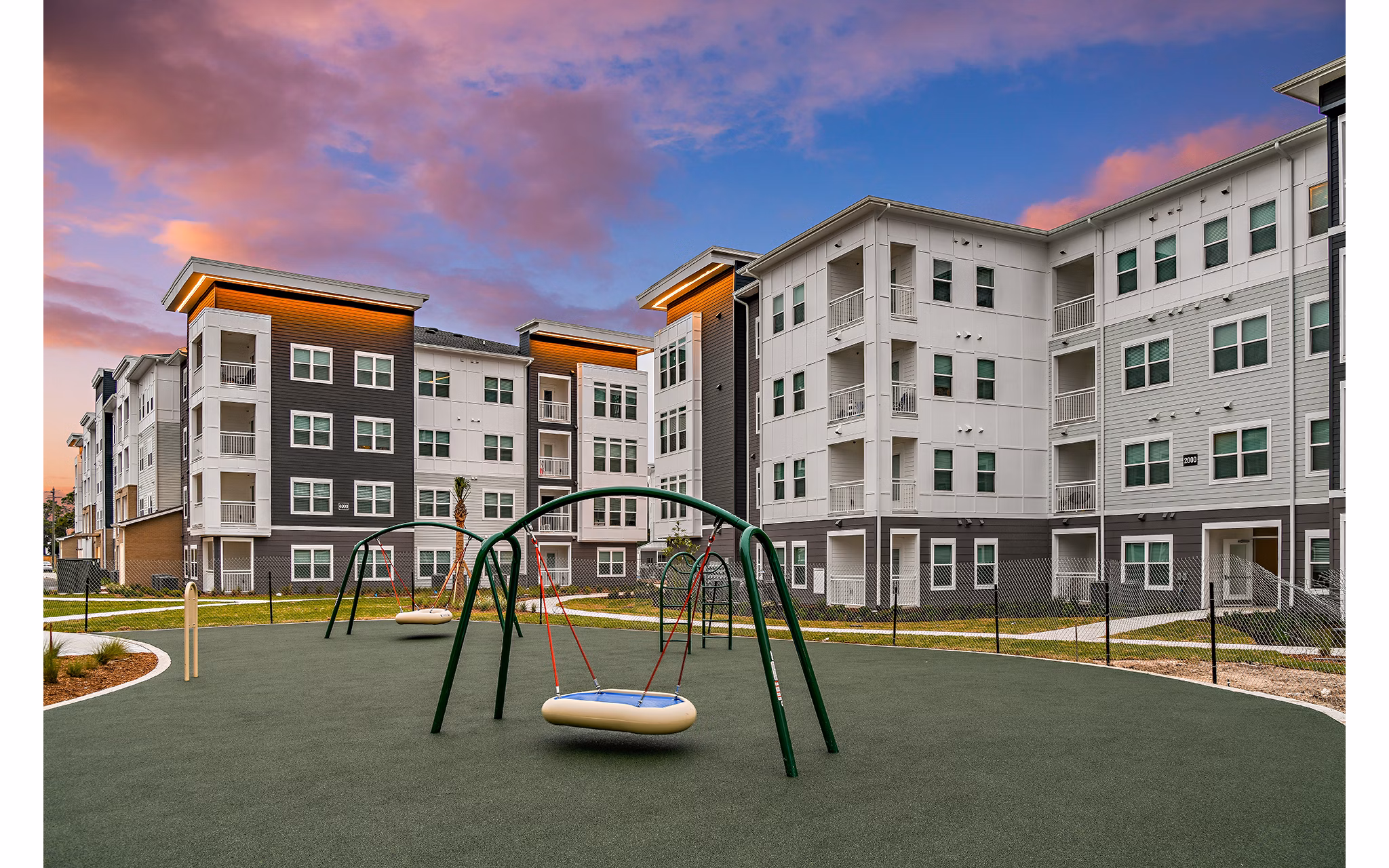 Modern playground with slides and swings at Renaissance Santa Rosa Apartments, ideal for family-friendly activities and outdoor fun