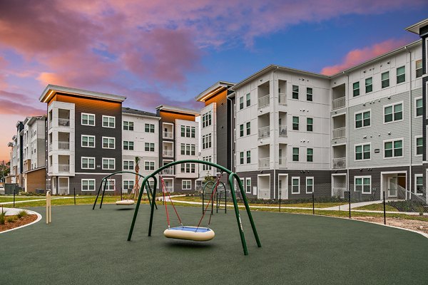 Modern playground with slides and swings at Renaissance Santa Rosa Apartments, ideal for family-friendly activities and outdoor fun