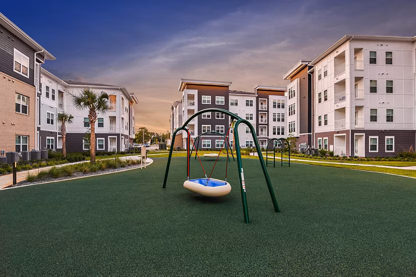 Modern playground at Renaissance Santa Rosa Apartments with slides and swings for children in a scenic residential community