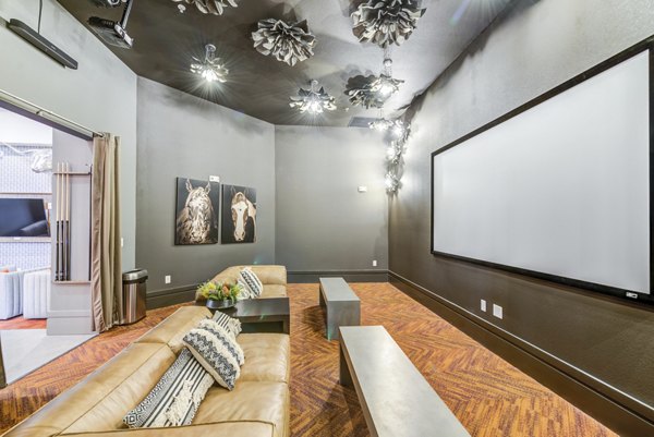 Monaco Midland Apartments: Luxury theater room with plush seating and sound system for ultimate viewing experience